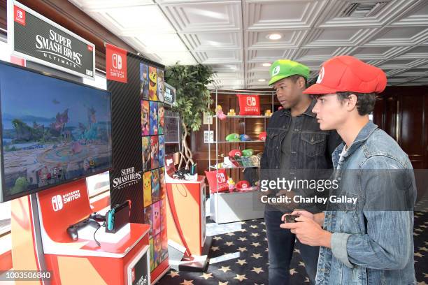 Luke Tennie and Benjamin Wadsworth test their skills on Super Smash Bros. Ultimate for Nintendo Switch at the Variety Studio at Comic-Con 2018 on...