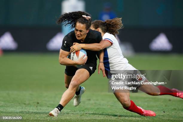 Partia Woodman of New Zealand is tackled by Fanny Horta of France during the Championship match on day two of the Rugby World Cup Sevens at AT&T Park...