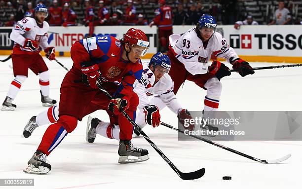 Maxim Afinogenov of Russia and Miroslac Blatak of Czech Republic battle for the puck during the IIHF World Championship gold medal match between...