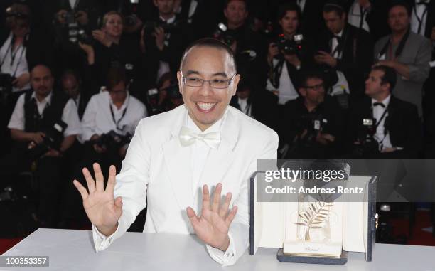 Director Apichatpong Weerasethakul poses with his Palme d'Or award for the film "Uncle Boonmee Who Can Recall His Past Lives" at the Palme d'Or Award...