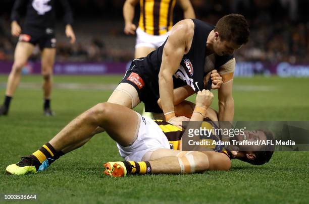 Marc Murphy of the Blues remonstrates with Daniel Howe of the Hawks after Howe struck Patrick Cripps of the Blues before a ball up during the 2018...