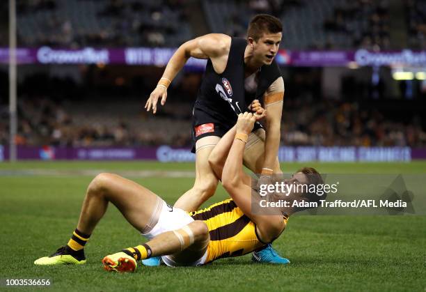 Marc Murphy of the Blues remonstrates with Daniel Howe of the Hawks after Howe struck Patrick Cripps of the Blues before a ball up during the 2018...