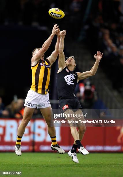 Brendan Whitecross of the Hawks and Matt Shaw of the Blues compete for the ball during the 2018 AFL round 18 match between the Carlton Blues and the...