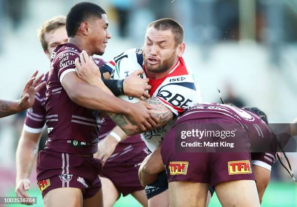 Jared Waerea-Hargreaves of the Roosters is tackled during the round 19 NRL match between the Manly Sea Eagles and the Sydney Roosters at Lottoland on...