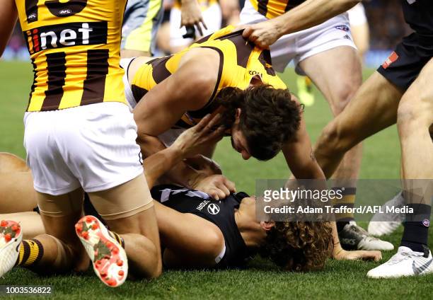 Ben Stratton of the Hawks and Charlie Curnow of the Blues share a laugh as they remonstrate with each other during the 2018 AFL round 18 match...
