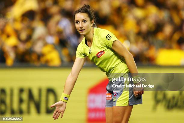 The first female AFL umpire, Ellen Glouftsis, officiates during the round 18 AFL match between the Carlton Blues and the Hawthorn Hawks at Etihad...