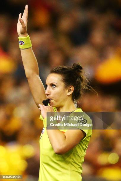 The first female AFL umpire, Ellen Glouftsis, officiates during the round 18 AFL match between the Carlton Blues and the Hawthorn Hawks at Etihad...