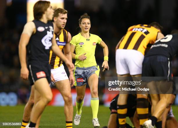 The first female AFL umpire, Ellen Glouftsis, officiates during the round 18 AFL match between the Carlton Blues and the Hawthorn Hawks at Etihad...