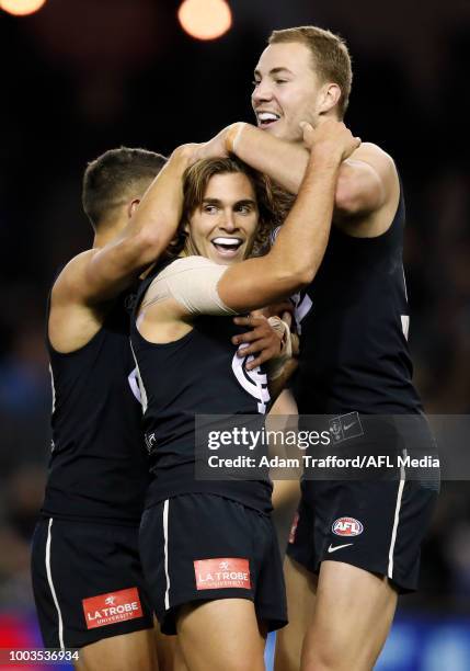 Cameron Polson of the Blues celebrates his first AFL goal with Jarrod Pickett and Harry McKay of the Blues during the 2018 AFL round 18 match between...