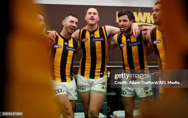 Brendan Whitecross, Jarryd Roughead and Ben Stratton of the Hawks sing the team song during the 2018 AFL round 18 match between the Carlton Blues and...