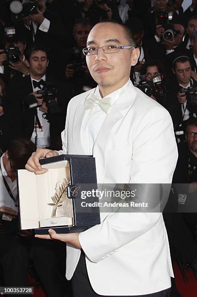 Director Apichatpong Weerasethakul poses with his Palme d'Or award for the film "Uncle Boonmee Who Can Recall His Past Lives" at the Palme d'Or Award...