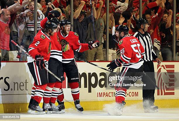 Dave Bolland of the Chicago Blackhawks reacts with teammates Duncan Keith, Kris Versteeg and Ben Eager after Bolland's second period goal while...