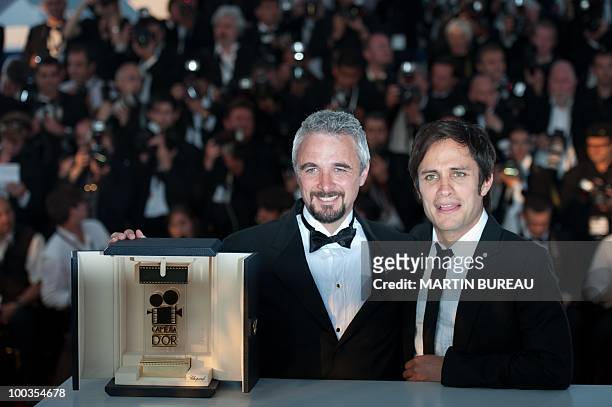 Director Michael Rowe poses flanked by Mexican actor and president of the jury of the Camera d'Or award Gael Garcia Bernal after winning the Camera...