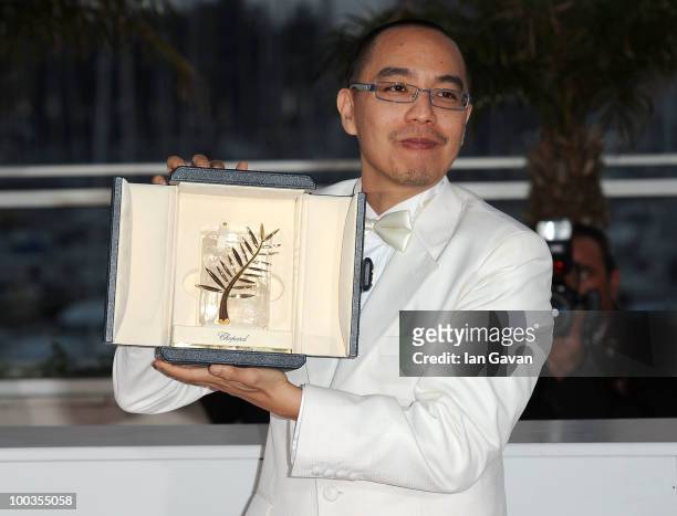 Director Apichatpong Weerasethakul poses with his Palme d'Or award for the film "Uncle Boonmee Who Can Recall His Past Lives" at the Palme d'Or Award...