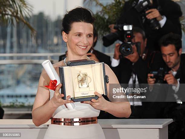 Actress Juliette Binoche poses with her Best Actress award for her role in "Certified Copy" at the Palme d'Or Award Ceremony photocall held at the...