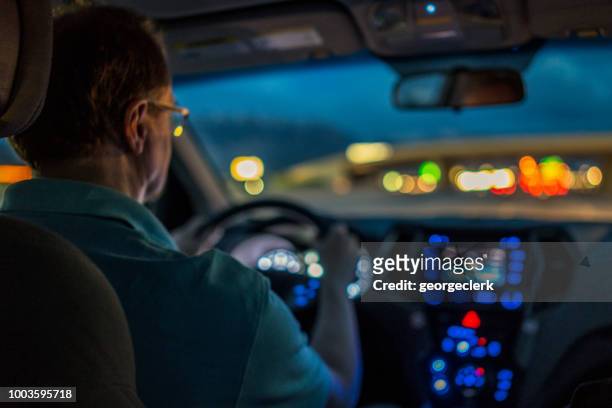 driver concentrating at night - car interior stock pictures, royalty-free photos & images