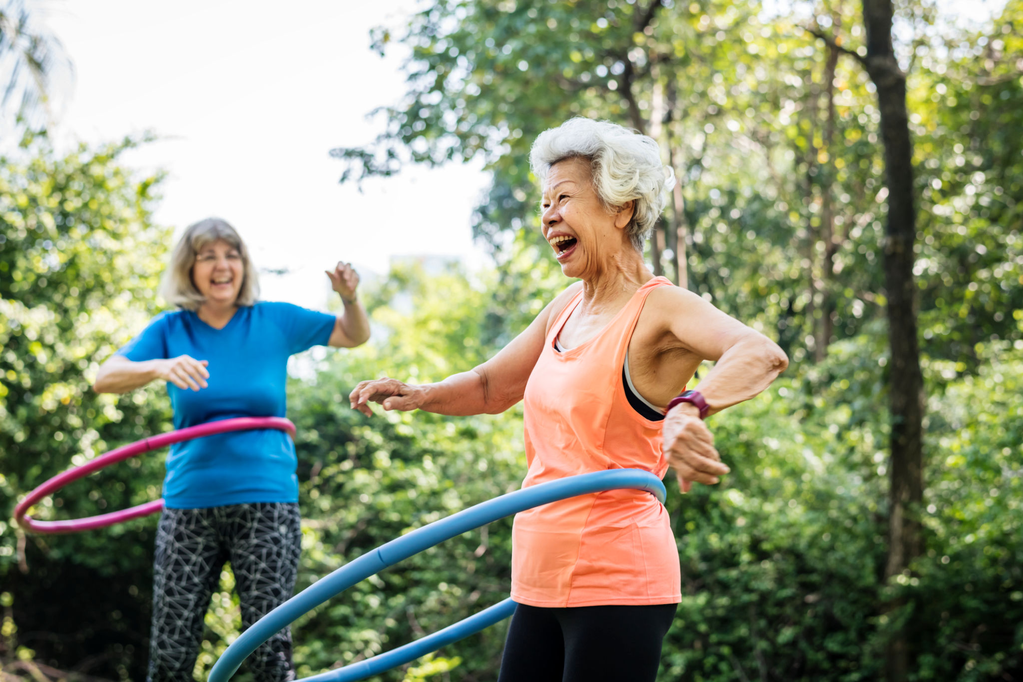 Senior woman exercising with a hula hoop Senior woman exercising with a hula hoop