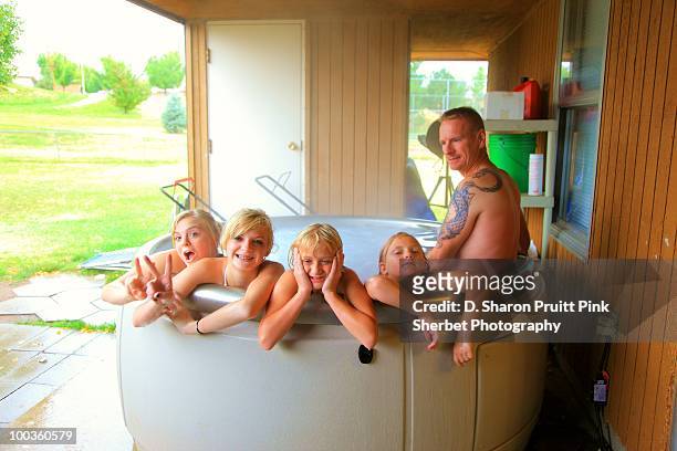 family relaxing together in the spa hot tub - girls in hot tub stockfoto's en -beelden