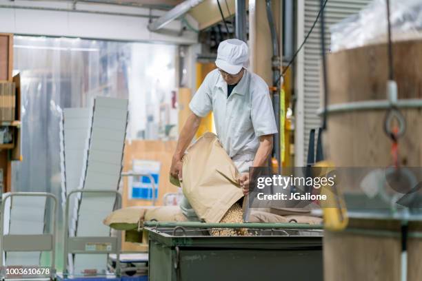 worker in a food processing factory - rice production stock pictures, royalty-free photos & images