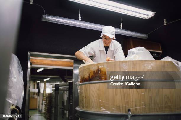 japanese worker inspecting miso - miso sauce stock pictures, royalty-free photos & images