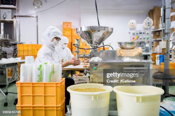 workers in a food processing factory packaging food - rice production stock pictures, royalty-free photos & images