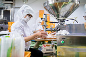 Workers in a food processing factory packaging food