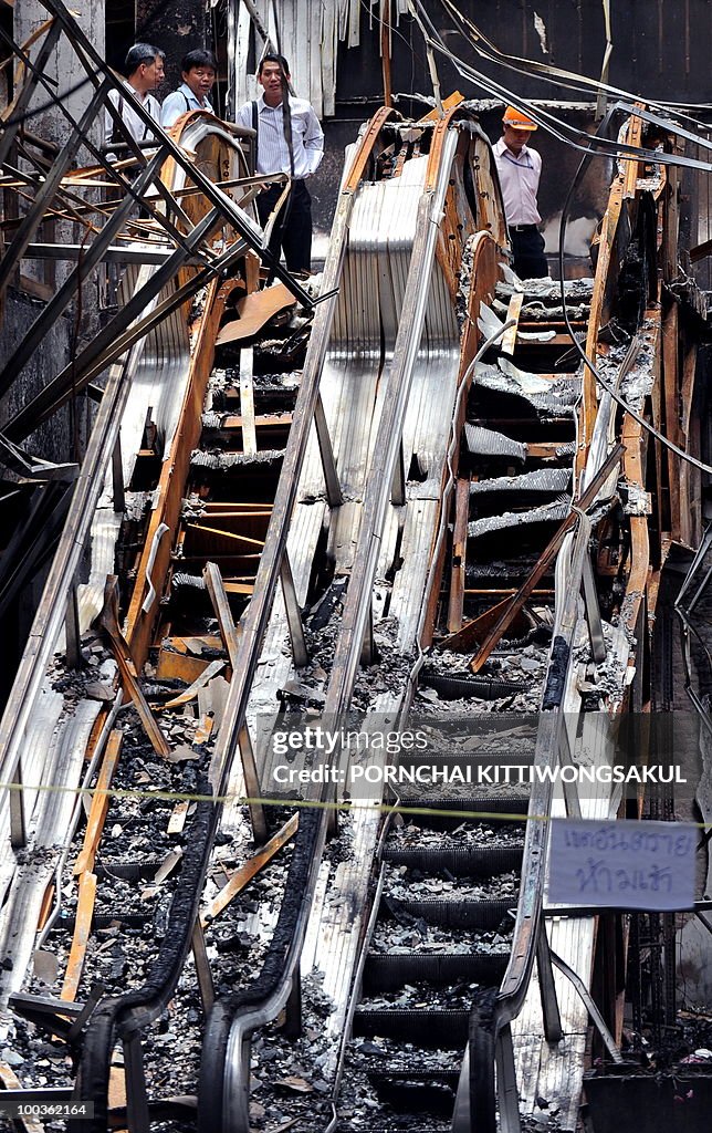 Thai technicians inspect the damage at a