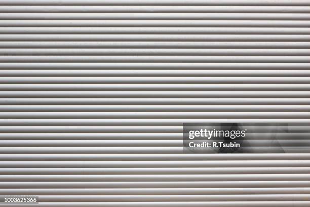 dirty metal roller shutter door as a background - shutter stock pictures, royalty-free photos & images