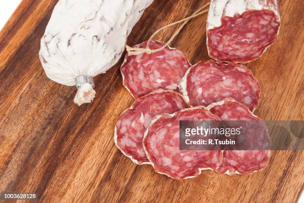 salami sausage on wooden board background - salami stock-fotos und bilder