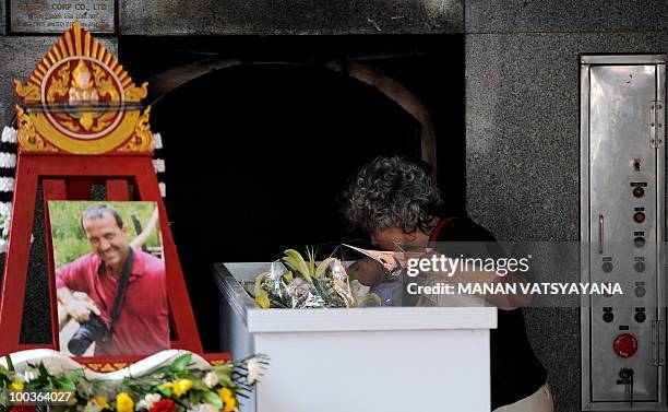 Isabella Polenghi, sister of slain Italian photograher Fabio Polenghi, pays her last respects at his funeral at a temple in Bangkok on May 24, 2010....