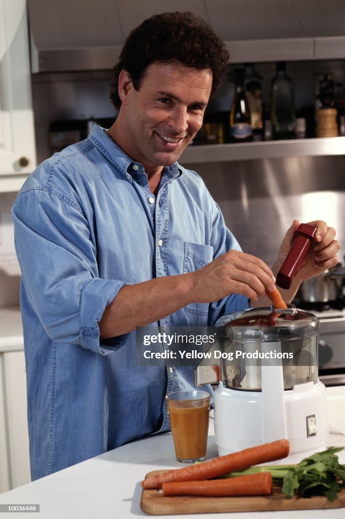 MAN MAKING VEGETABLE JUICE
