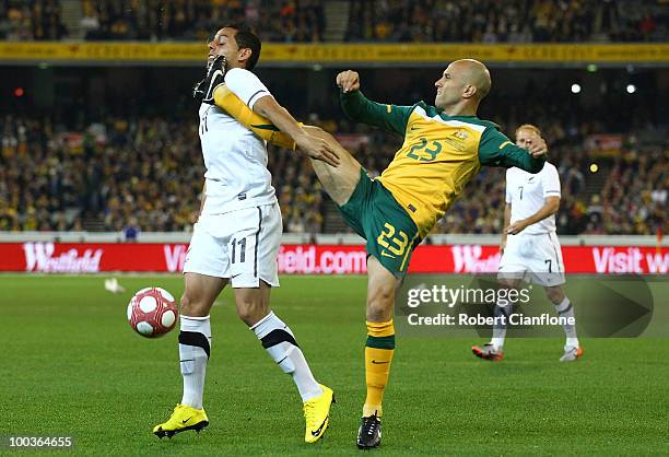 Leo Bertos of New Zealand is challenged by Mark Bresciano of Australia during the 2010 FIFA World Cup Pre-Tournament match between the Australian...