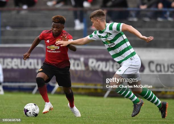 Largie Ramazani of Manchester United and Lewis Bell of Celtic during the U19 NI Super Cup gala match at Coleraine Showgrounds on July 21, 2018 in...
