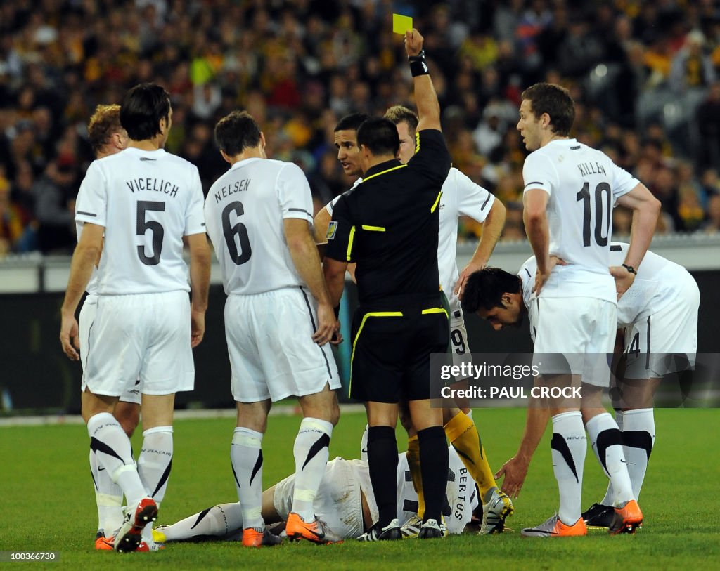 Tim Cahill of Australia is given a yello