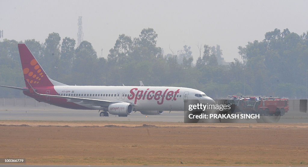 Fire trucks surround a Spicejet Boeing 7