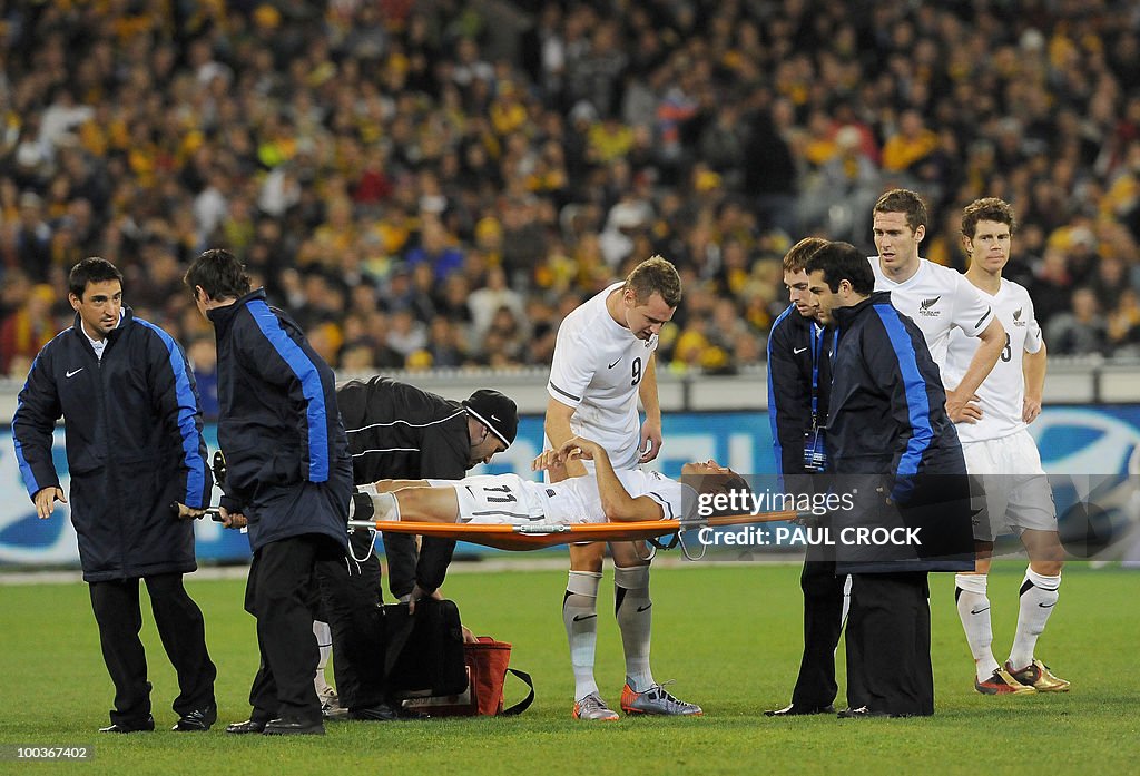 Leo Bertos of New Zealand is carried off