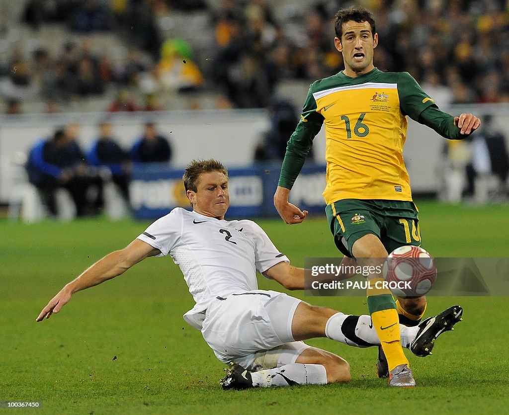 Ben Sigmund of New Zealand (L) tries a s