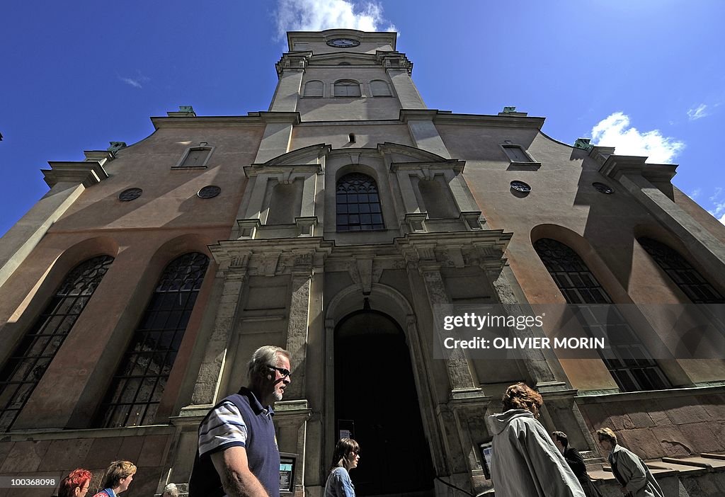 Tourists pass by the Cathedral, near the