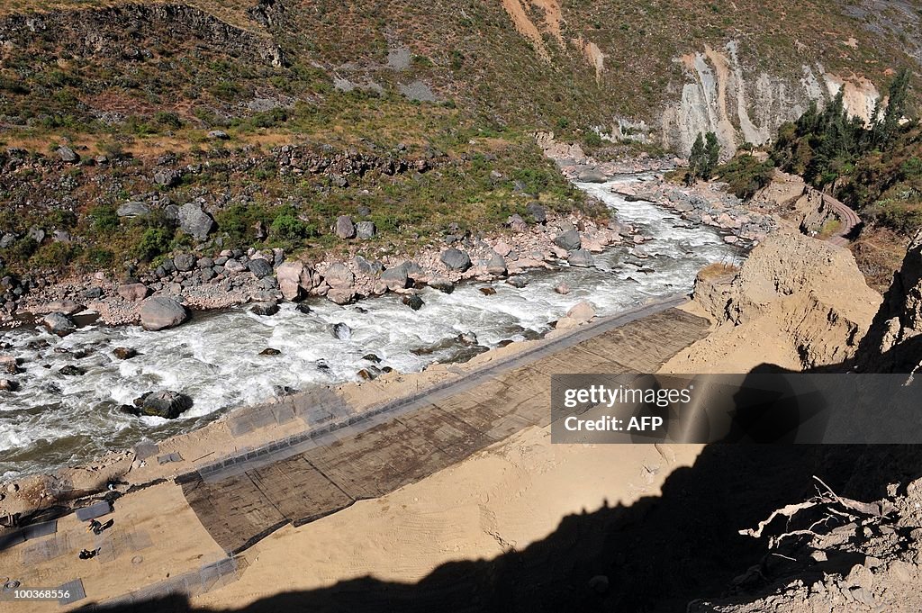 Workers repair on May 23, 2010, a road c