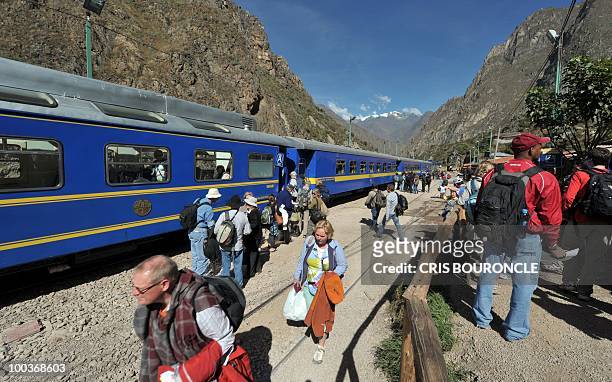 Hundreds of tourists board a train from an intermediate station between the Andean city of Cuzco and the Inca fortress citadel Machu Picchu on May...