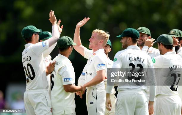 Worcestershire bowler Luke Wood celebrates with team mates after taking his first Worcestershire wicket during Day One of the Specsavers County...