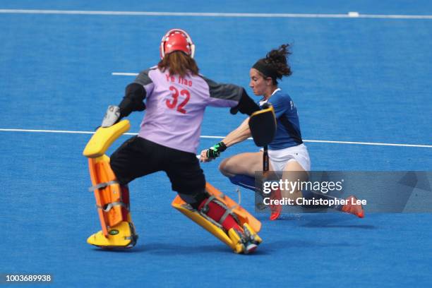 Elisabetta Pacella of Italy gets the ball through the legs of goalkeeper Jiao Ye of China during the Pool A game between China and Italy of the FIH...