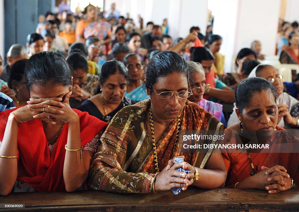 Relatives and mourners attend a funeral