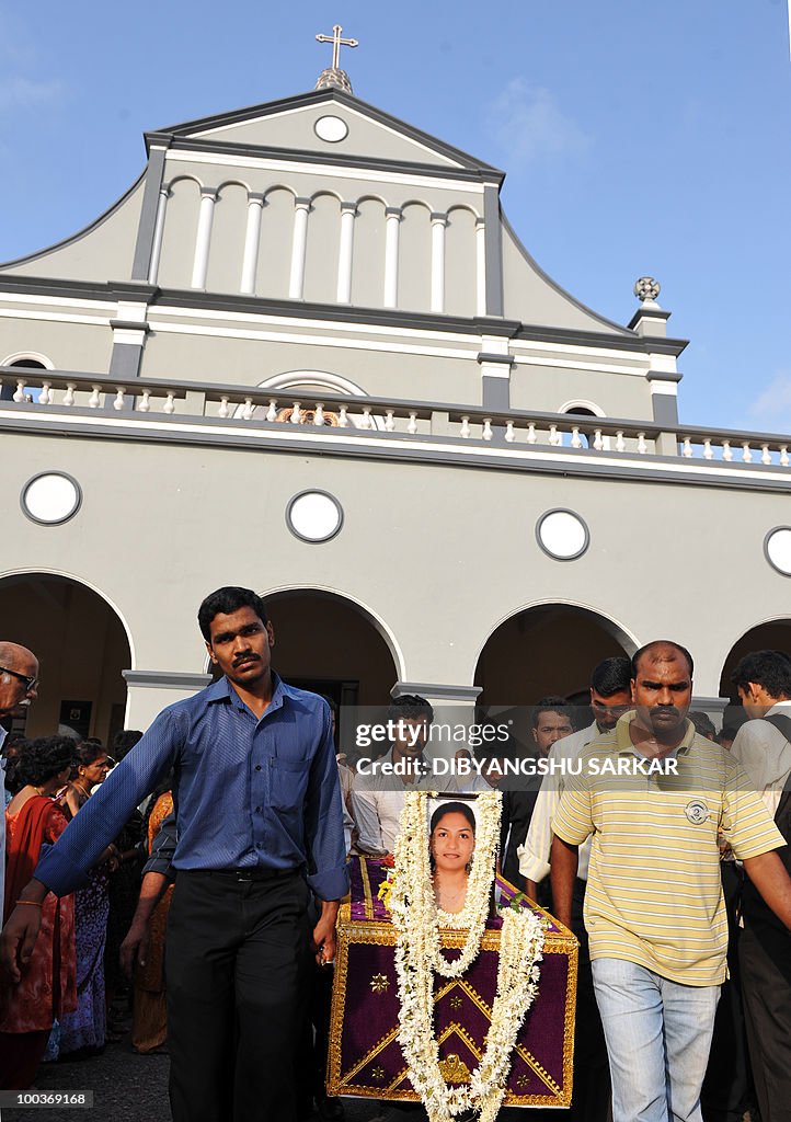 Relatives and mourners carry the coffin