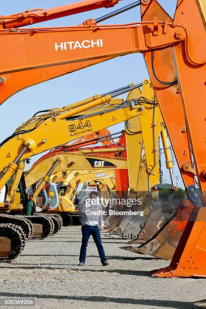 Gared Rank looks at hydraulic excavators made by Hitachi Ltd., Liebherr, Caterpillar Inc., and Deere & Co. Before a Ritchie Bros. Auctioneers Inc....