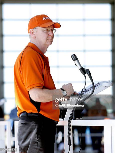 Peter Blake, chief executive officer of Ritchie Bros. Auctioneers Inc., spots bids during an industrial equipment auction in Dunnigan, California,...