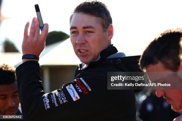 Adam Skrobalak senior coach of Frankston speaks to players during the round 16 VFL match between Frankston and North Melbourne at SkyBus Stadium on...