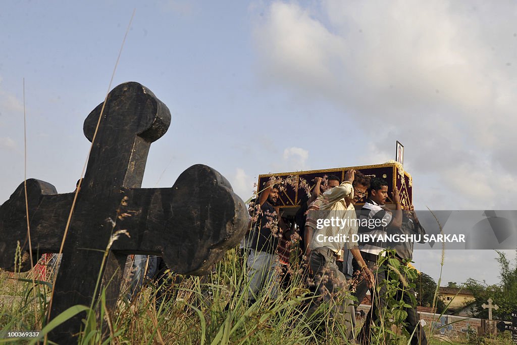 Relatives and mourners carry the coffin