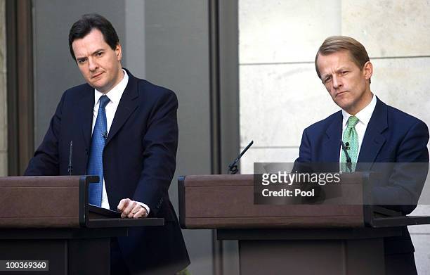 David Laws, U.K. Chief treasury secretary, right, and George Osborne, U.K. Chancellor of the exchequer, pause during a press conference at...