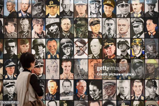 Woman stands in front of the work 'Real Nazis' by Piotr Uklanski in the Hessian State Museum in Kassel, Germany, 09 June 2017. The documenta 14 will...